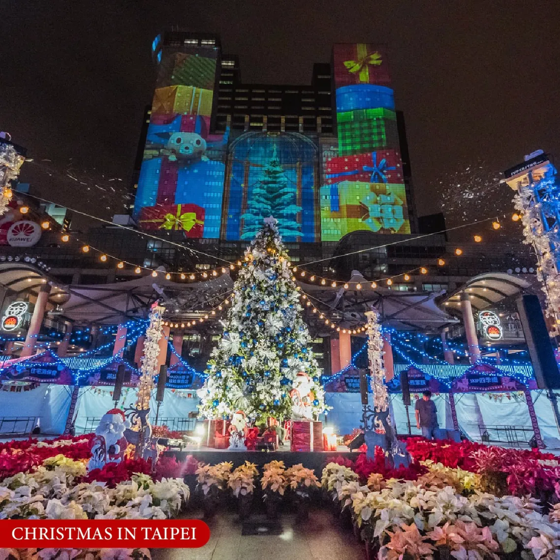 ต้นคริสต์มาสประดับไฟและการยิงกราฟิกแสงสีบนตึกสูงในงาน Christmasland เมืองไทเป